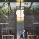man passing an apple store